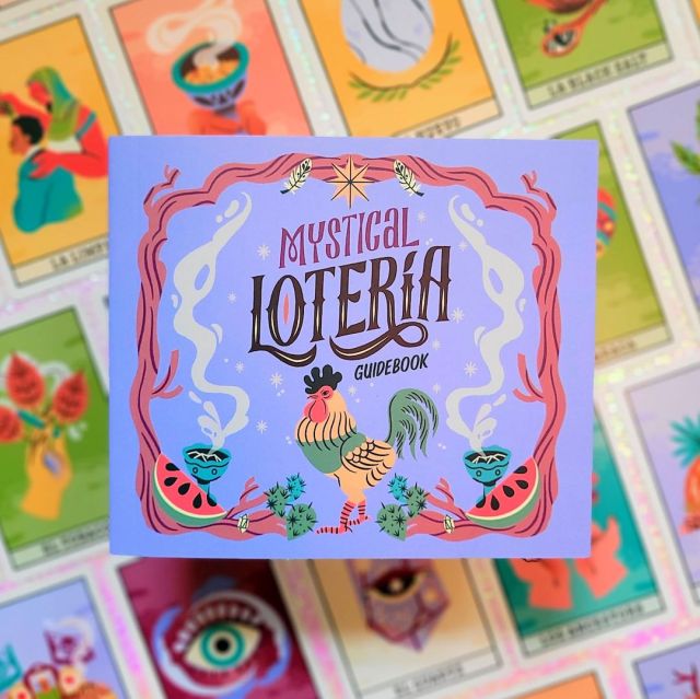 Photo of the guidebook of “Mystical Lotería: A Spiritual Celebration of the Classic Latin Party Game” laid above face-up cards from the game
